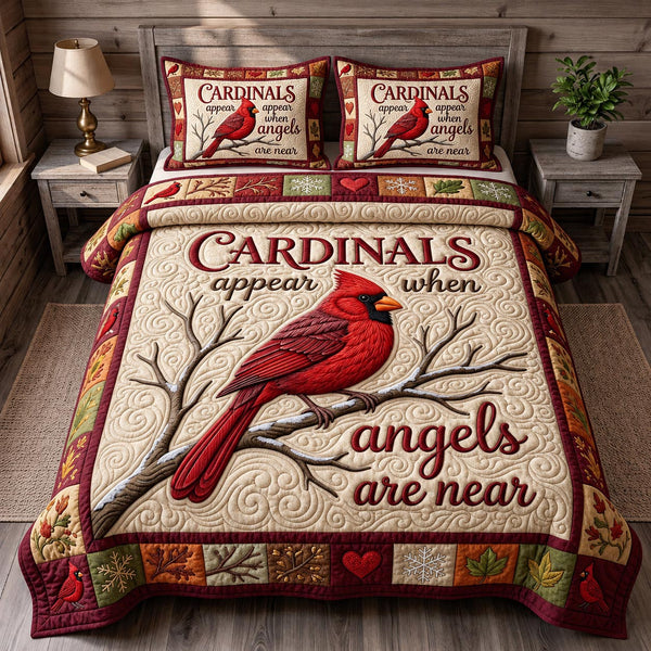 Red Cardinal in Blush quilted bedding set, quilt and two pillow shams on a made bed