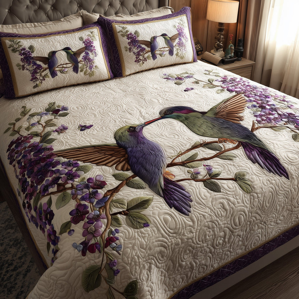 Amethyst Love Hummingbirds on Cream with Lilac Sprays quilted bedding set, quilt and two pillow shams on a made bed