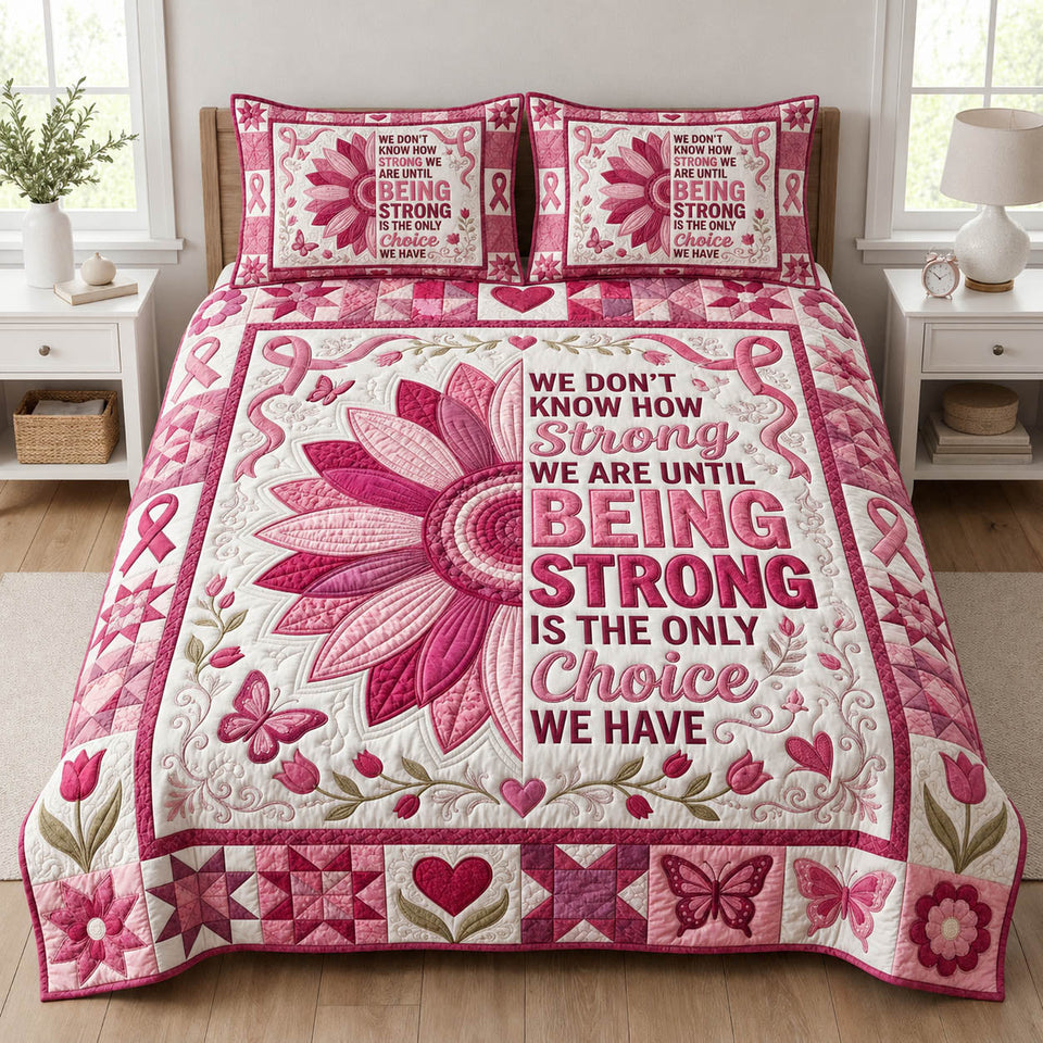 Being Strong Pink Petals quilted bedding set, quilt and two pillow shams on a made bed