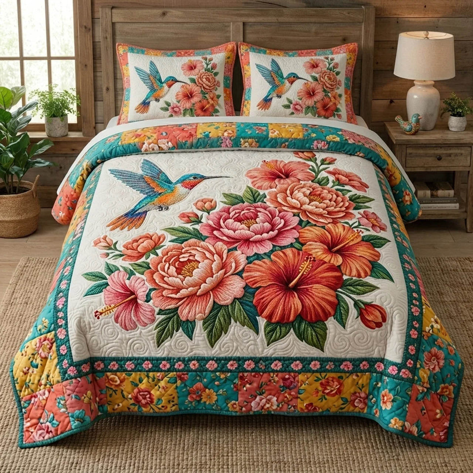 Bloom Garden Hummingbird Over Peonies quilted bedding set, quilt and two pillow shams on a made bed