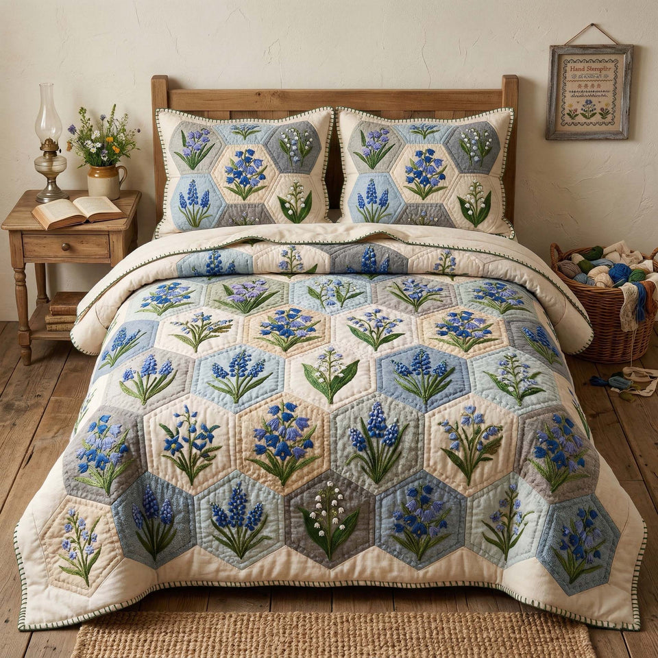 Blossom Grace Blue Hexagons with Bellflowers quilted bedding set, quilt and two pillow shams on a made bed