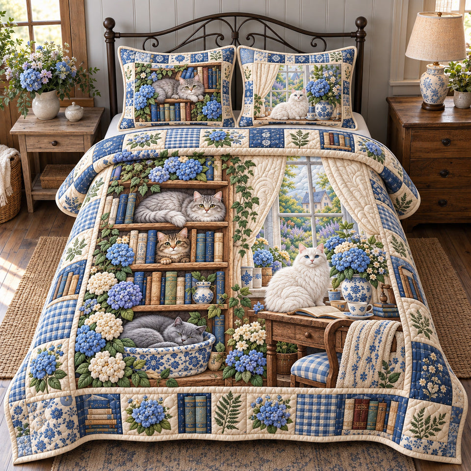 Blue Hydrangea Cats Library quilted bedding set, quilt and two pillow shams on a made bed