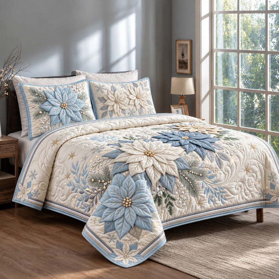 Blue Poinsettia quilted bedding set, quilt and two pillow shams on a made bed