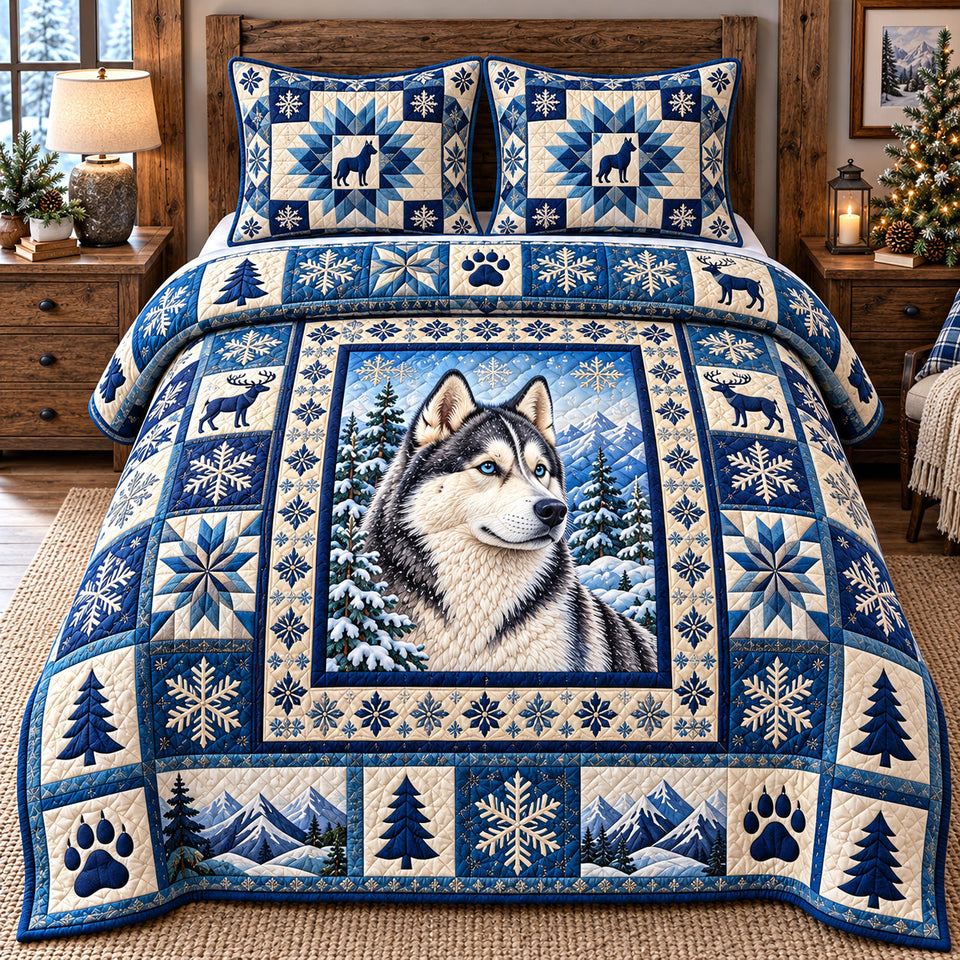 Blue Snowflake Husky quilted bedding set, quilt and two pillow shams on a made bed