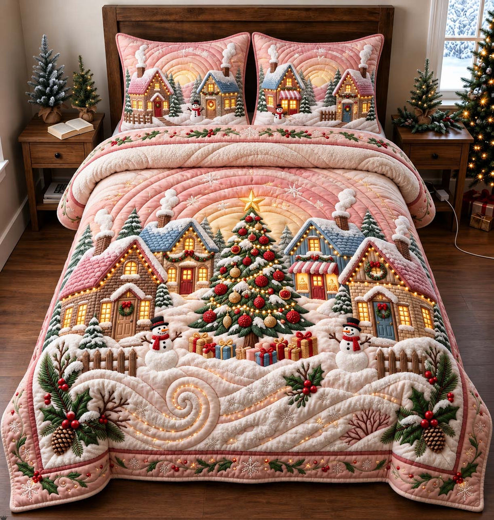 Blush Winter Village quilted bedding set, quilt and two pillow shams on a made bed