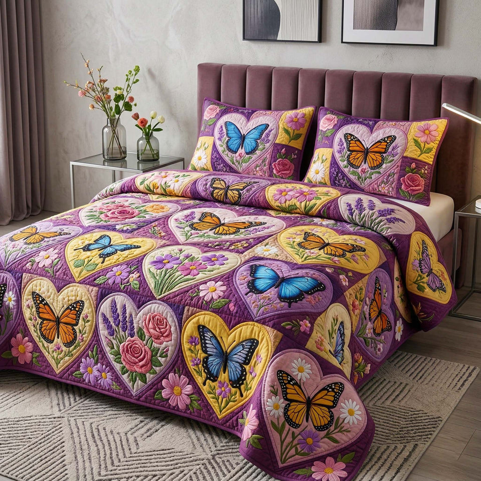 Butterfly Heart Floral quilted bedding set, quilt and two pillow shams on a made bed