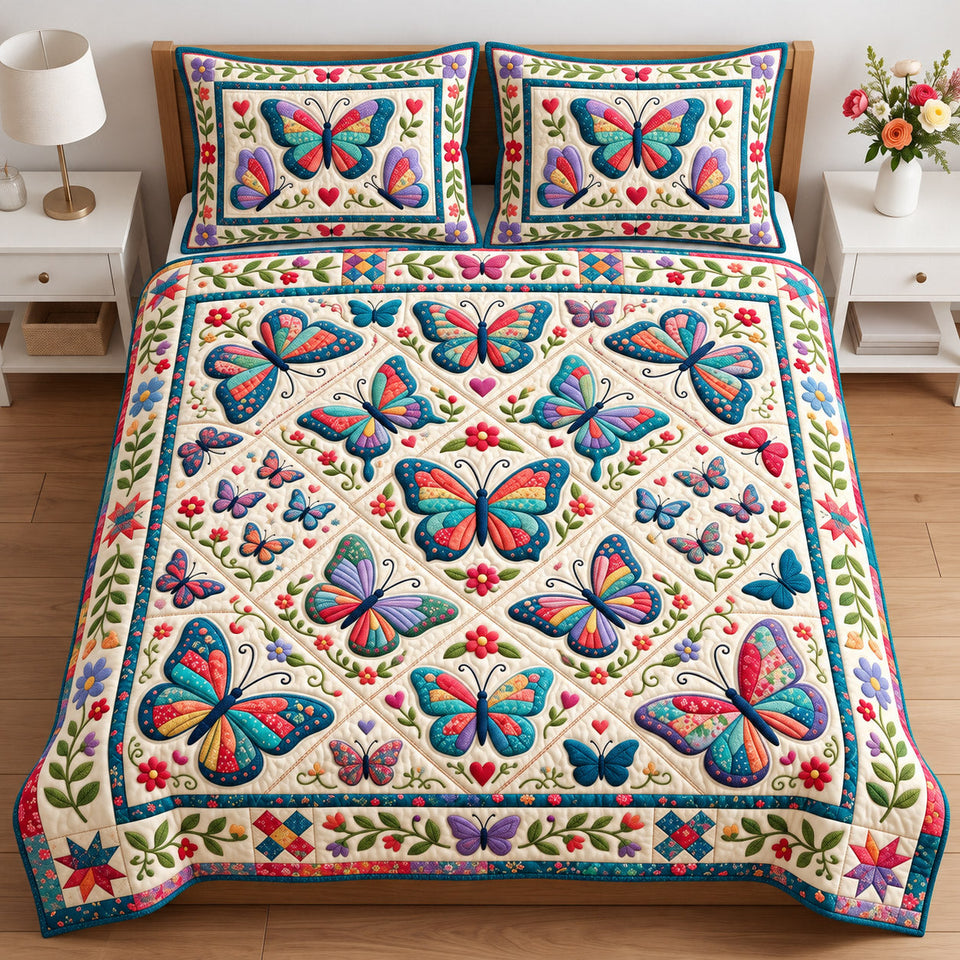 Butterfly Patchwork quilted bedding set, quilt and two pillow shams on a made bed
