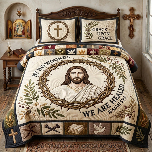 By His Wounds quilted bedding set, quilt and two pillow shams on a made bed