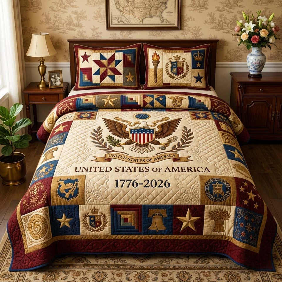 Classic Emblem quilted bedding set, quilt and two pillow shams on a made bed