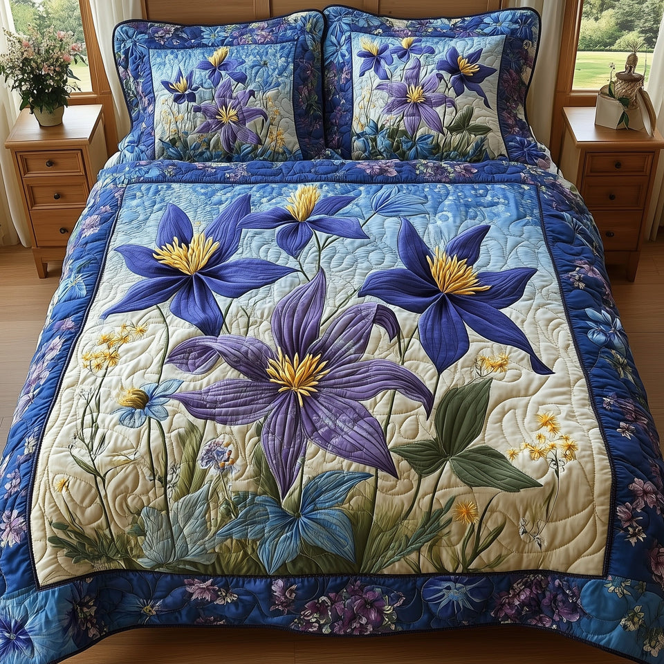 Columbine Charm Pale Blue Ground Floral Border quilted bedding set, quilt and two pillow shams on a made bed