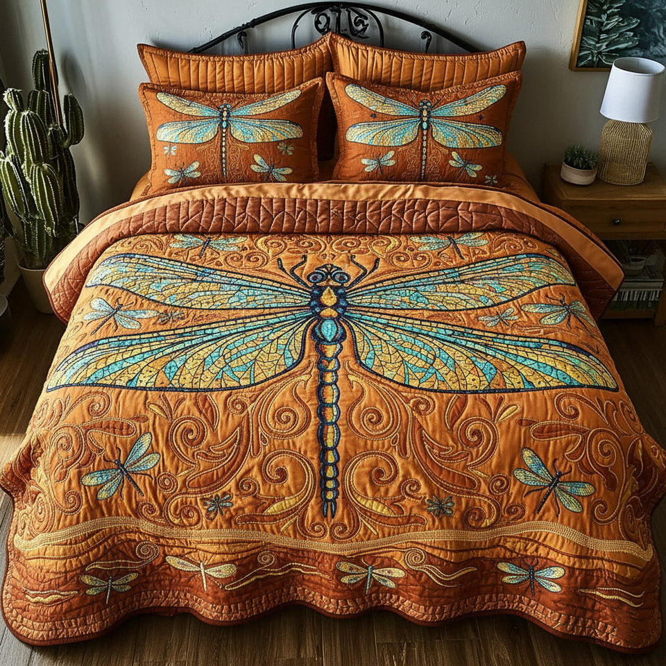 Dragonfly Amber Scroll Ground quilted bedding set, quilt and two pillow shams on a made bed