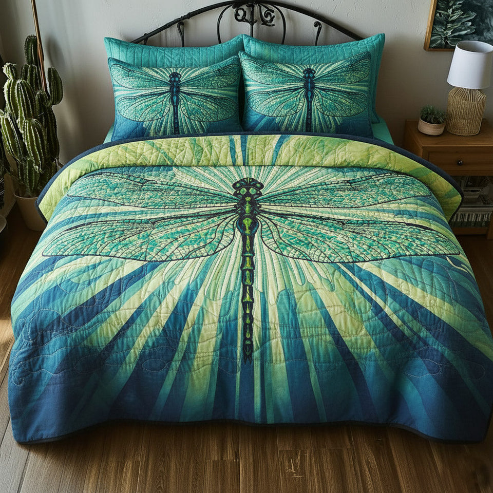 Dragonfly Aqua Green Sunburst quilted bedding set, quilt and two pillow shams on a made bed