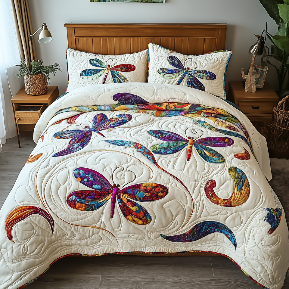 Elegance Dragonfly Paisley Wing Pair quilted bedding set, quilt and two pillow shams on a made bed