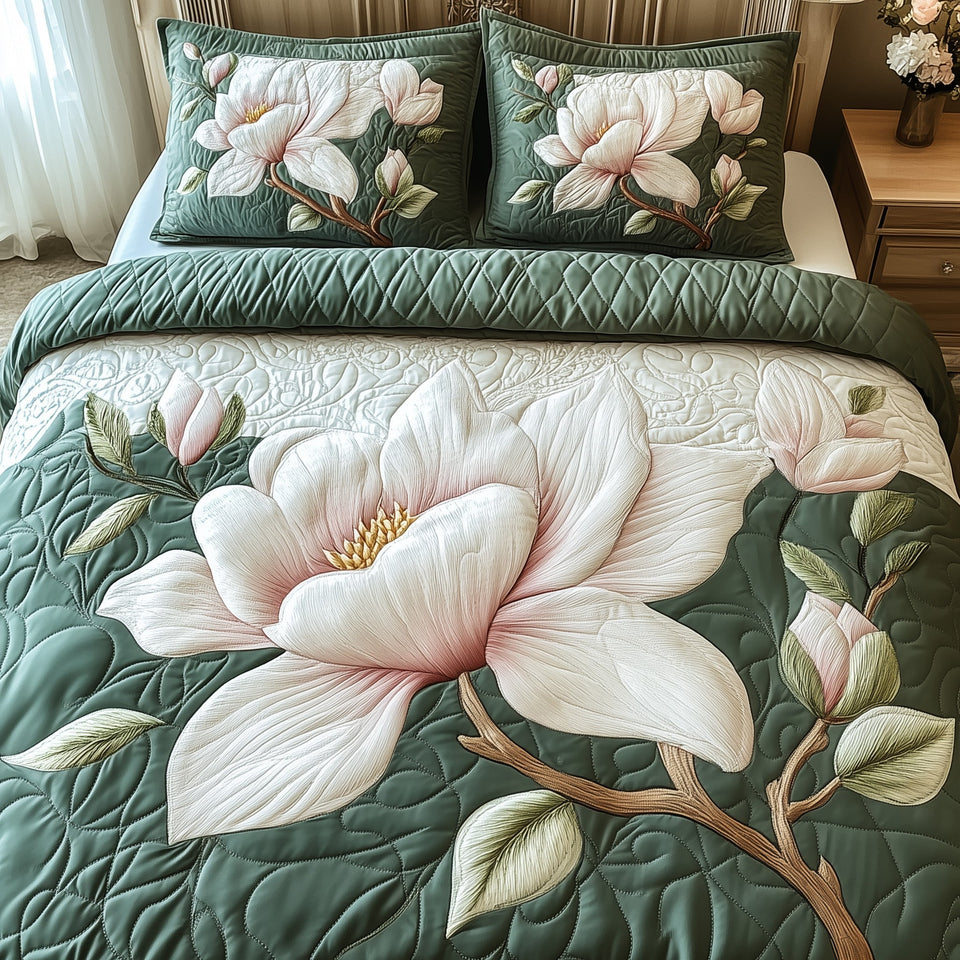 Elegant Blooming Magnolia Twin Blooms Teal Fold quilted bedding set, quilt and two pillow shams on a made bed