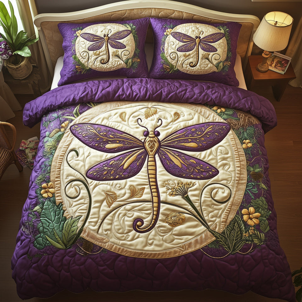 Glowing Dragonfly quilted bedding set, quilt and two pillow shams on a made bed