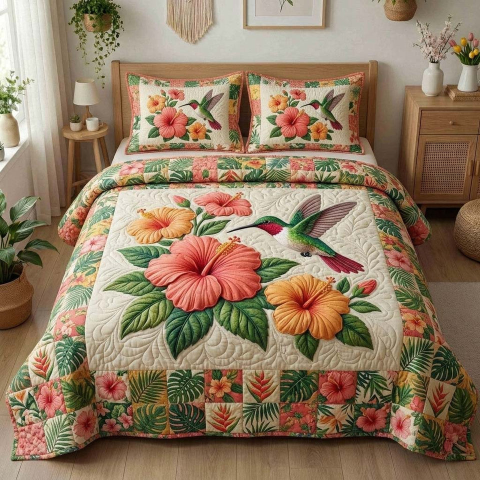 Hibiscus Hummingbird Haven quilted bedding set, quilt and two pillow shams on a made bed