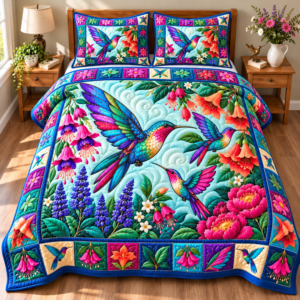 Hummingbird Blossom Haven quilted bedding set, quilt and two pillow shams on a made bed