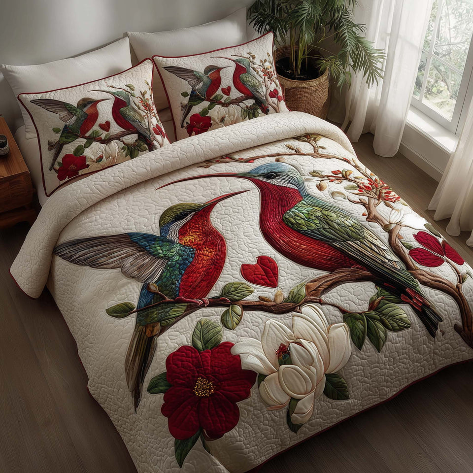 Hummingbird Embrace Red Blossoms on Cream quilted bedding set, quilt and two pillow shams on a made bed