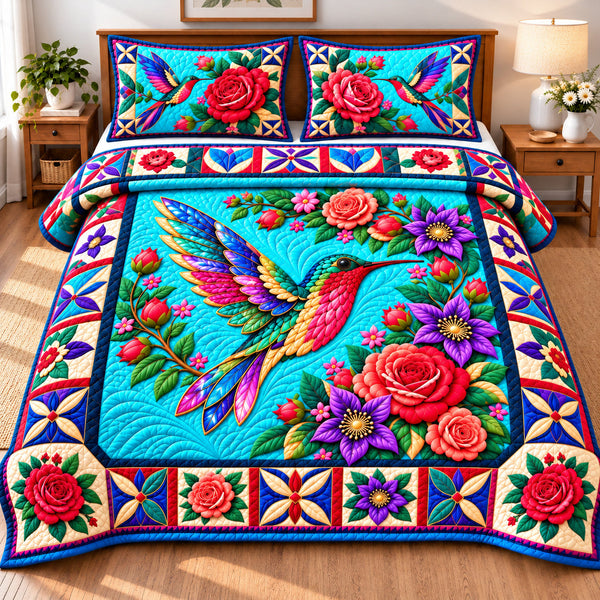 Hummingbird Garden Dance quilted bedding set, quilt and two pillow shams on a made bed
