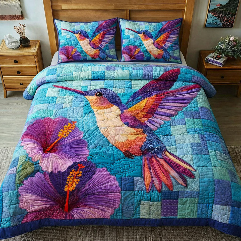 Hummingbird Hibiscus Splash quilted bedding set, quilt and two pillow shams on a made bed