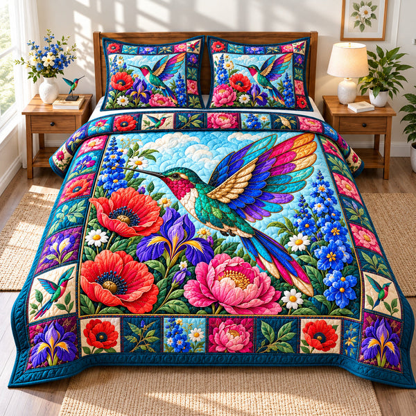 Hummingbird Jewel Garden quilted bedding set, quilt and two pillow shams on a made bed