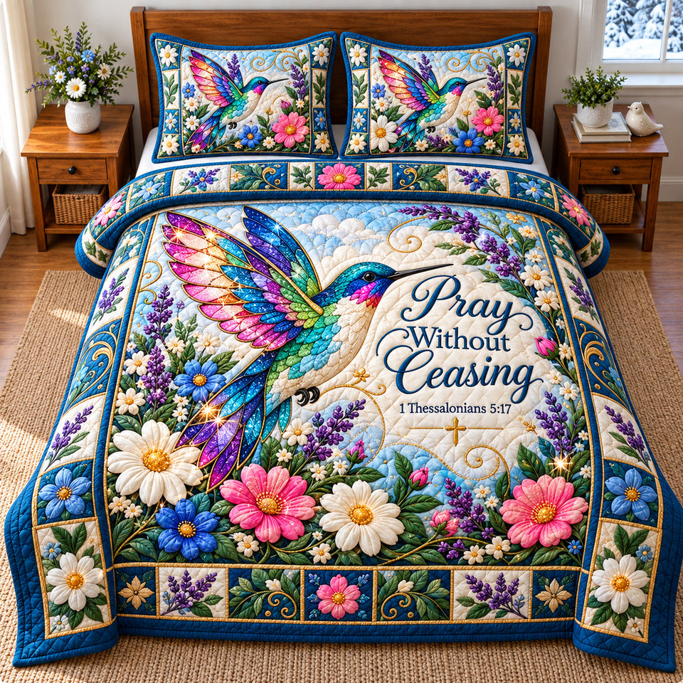 Hummingbird Summer Paradise quilted bedding set, quilt and two pillow shams on a made bed