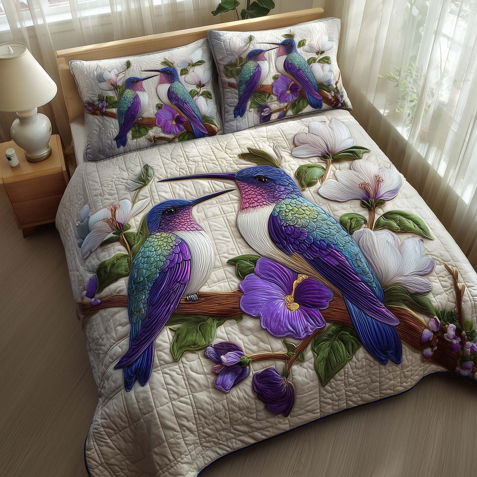 Hummingbird Violet Garden quilted bedding set, quilt and two pillow shams on a made bed