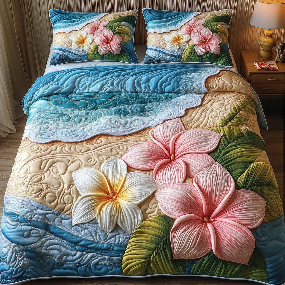 Island Plumera Paradise Pink Shoreline quilted bedding set, quilt and two pillow shams on a made bed