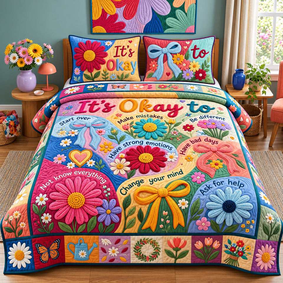 Its Okay quilted bedding set, quilt and two pillow shams on a made bed