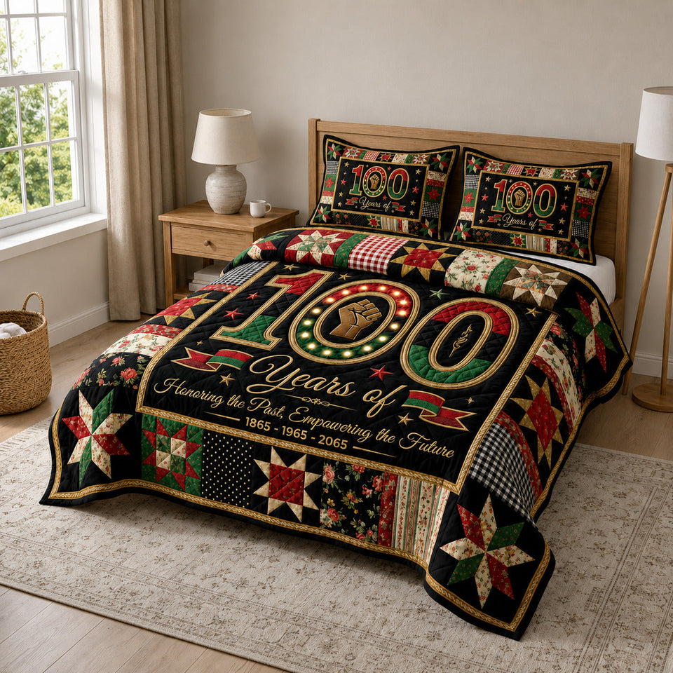 Juneteenth Pride quilted bedding set, quilt and two pillow shams on a made bed