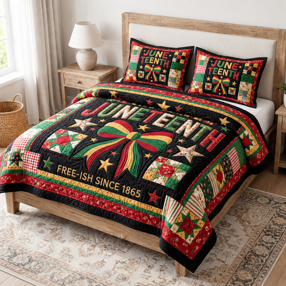 Juneteenth Spirit quilted bedding set, quilt and two pillow shams on a made bed