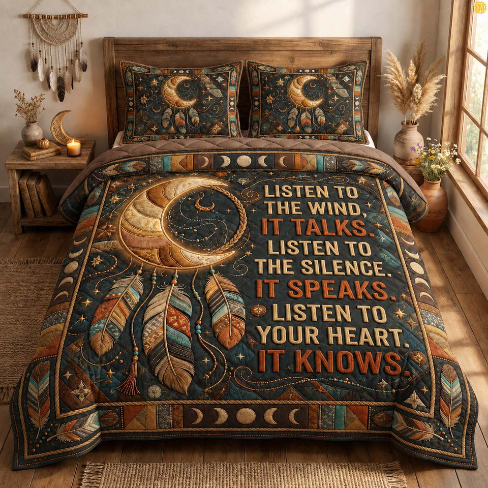 Listen Wind Spirit quilted bedding set, quilt and two pillow shams on a made bed