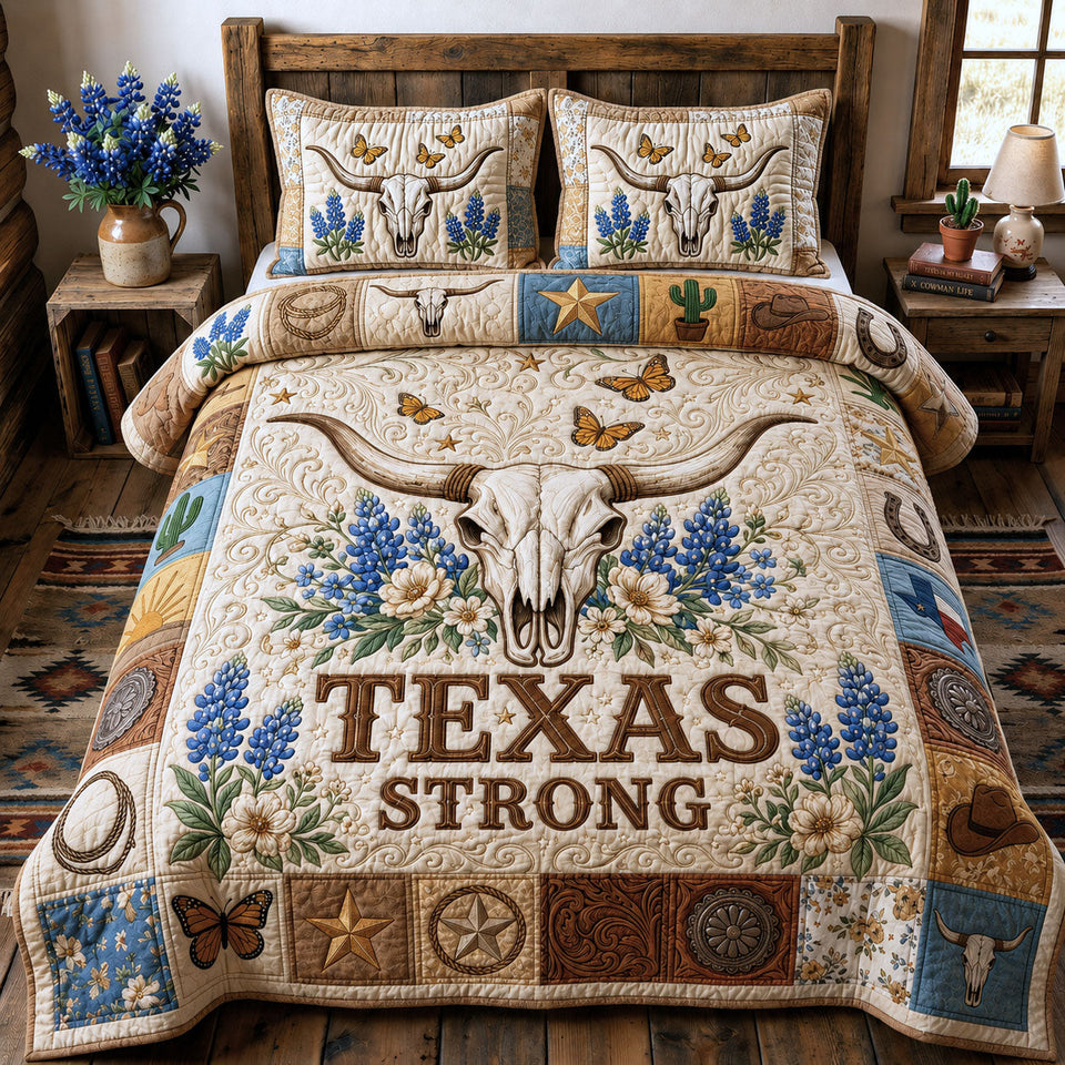 Longhorn Skull Texas Strong Bluebonnets quilted bedding set, quilt and two pillow shams on a made bed