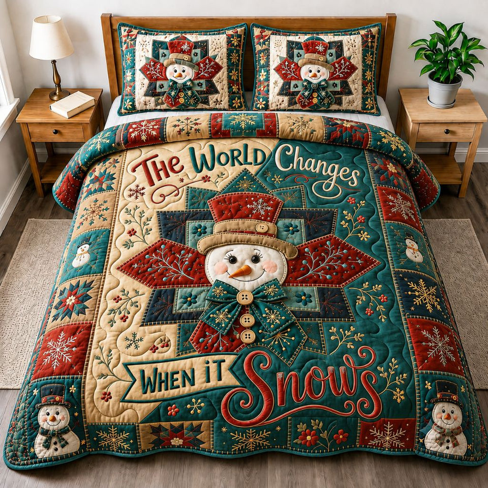 Merry Snowman Wonderland quilted bedding set, quilt and two pillow shams on a made bed