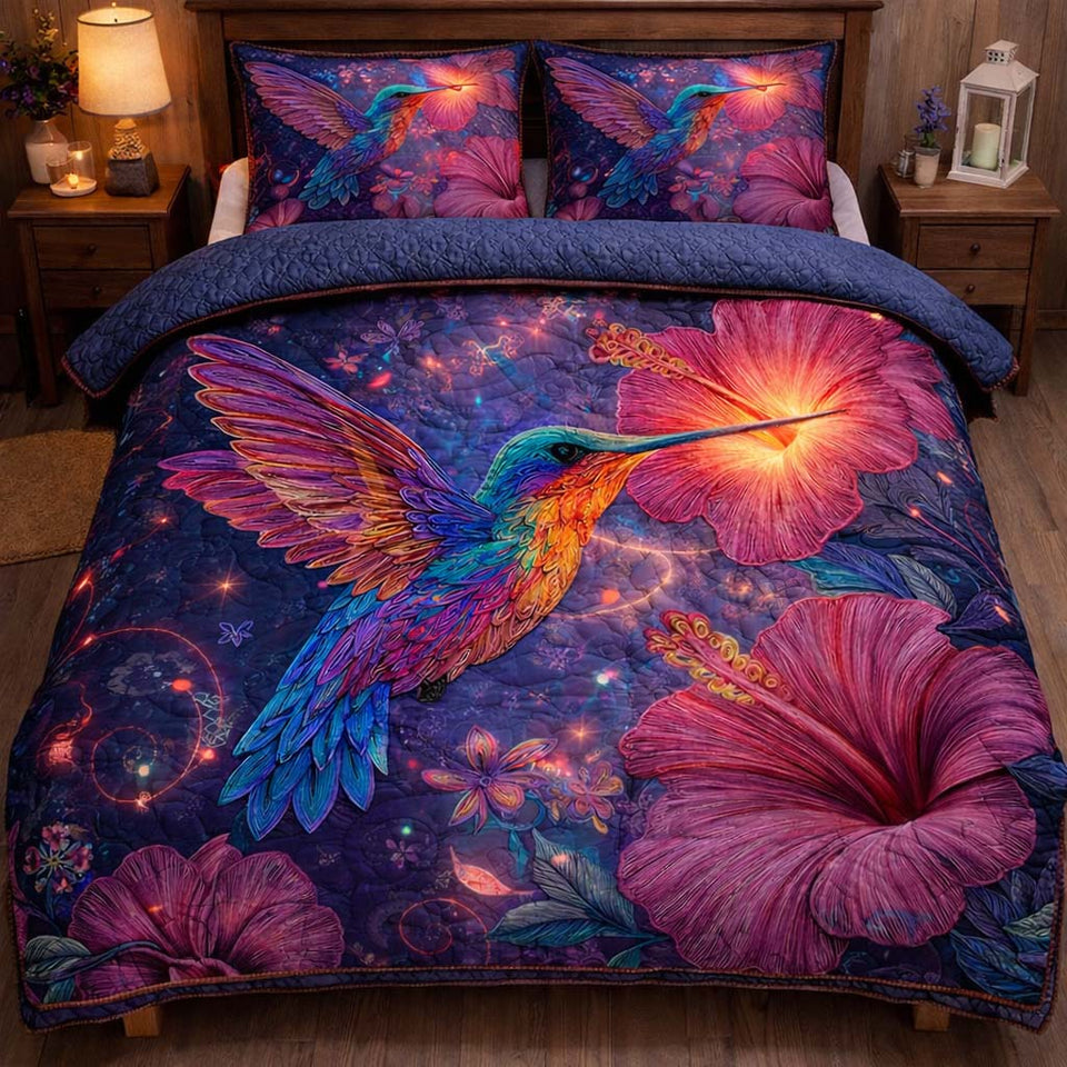 Mystic Glow Hummingbird quilted bedding set, quilt and two pillow shams on a made bed