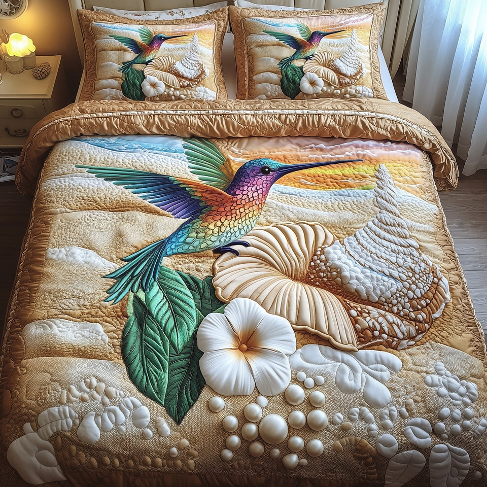 Ocean Breeze Hummingbird quilted bedding set, quilt and two pillow shams on a made bed