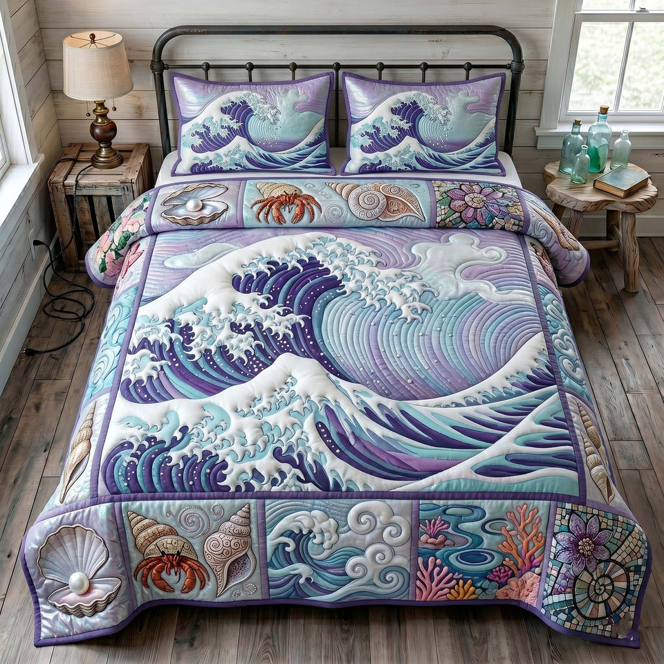 Ocean Tide Violet Wave and Coral Border quilted bedding set, quilt and two pillow shams on a made bed