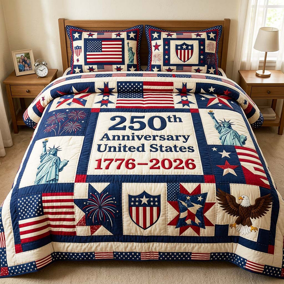 Patriot Anniversary quilted bedding set, quilt and two pillow shams on a made bed