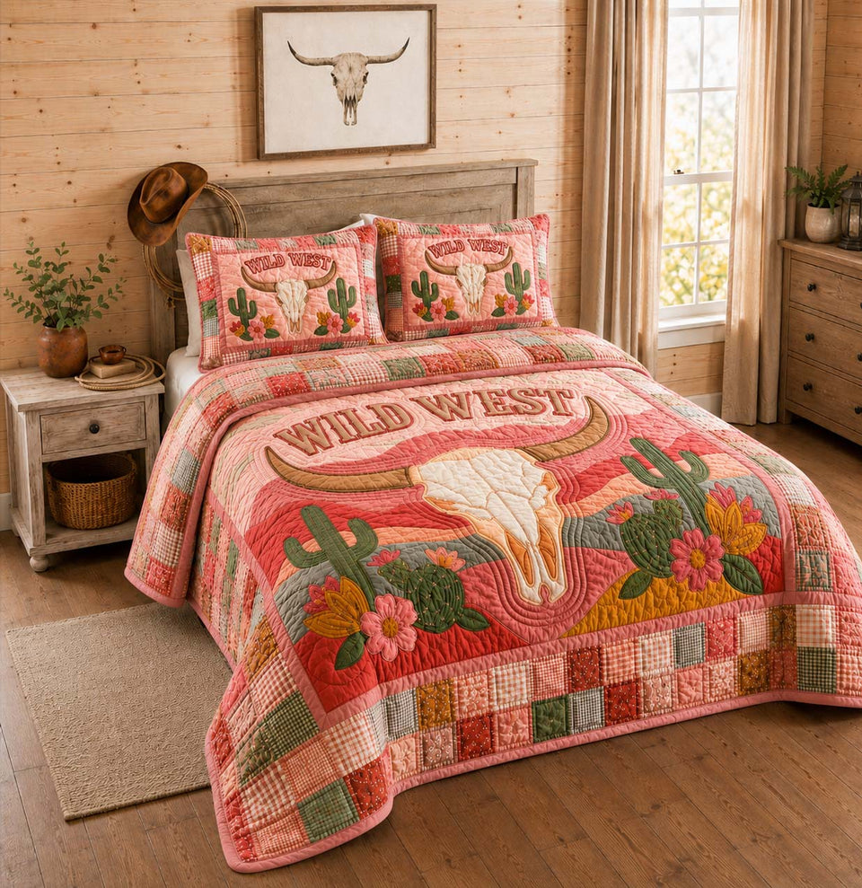 Pink Desert Skull quilted bedding set, quilt and two pillow shams on a made bed