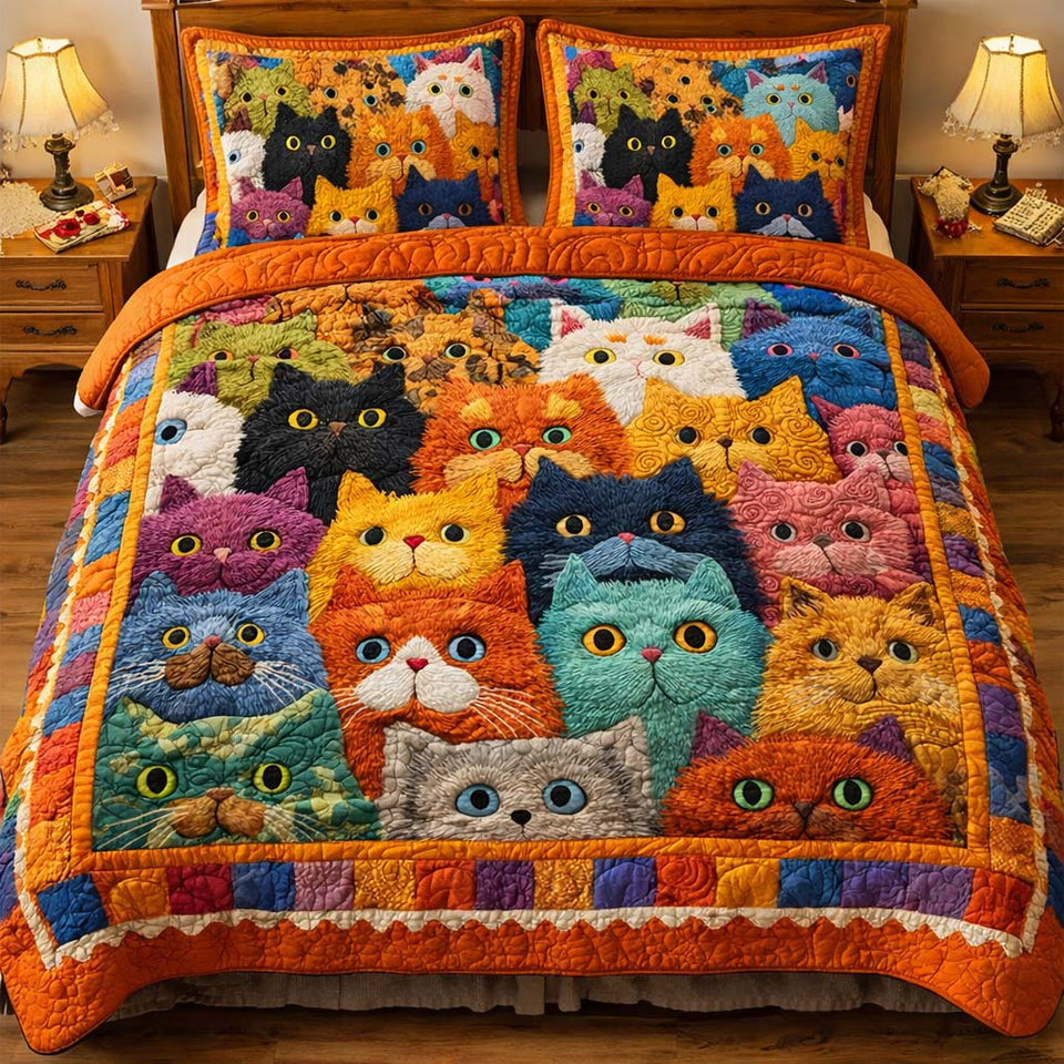 Playful Cats quilted bedding set, quilt and two pillow shams on a made bed