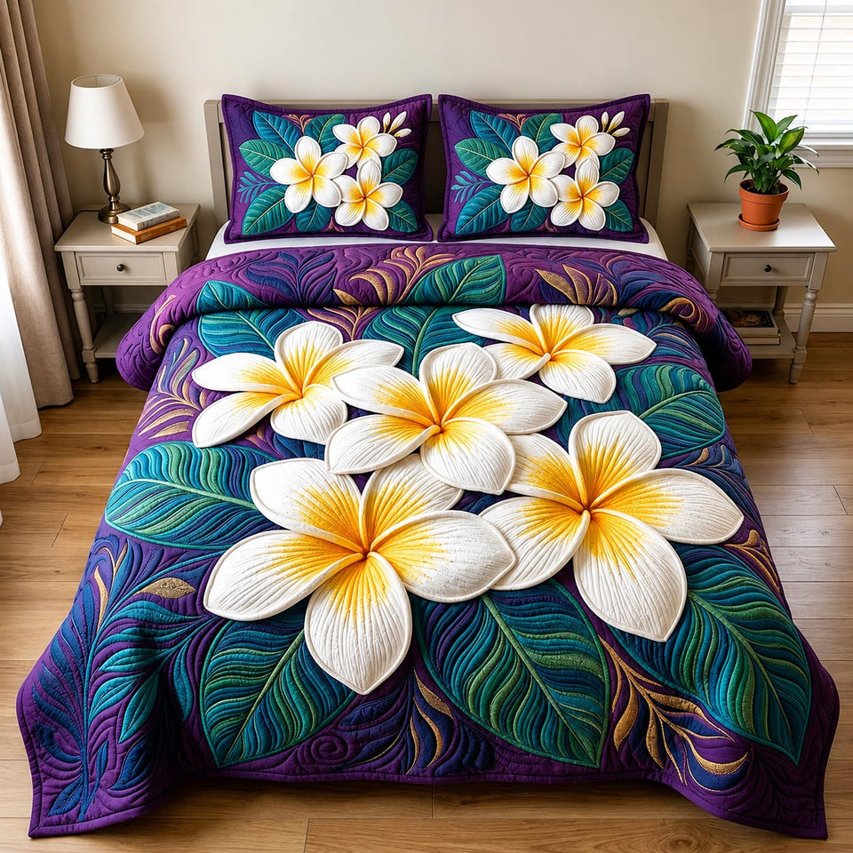 Plumeria Blossom quilted bedding set, quilt and two pillow shams on a made bed