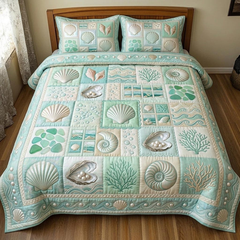 Seafoam Shell Gems quilted bedding set, quilt and two pillow shams on a made bed