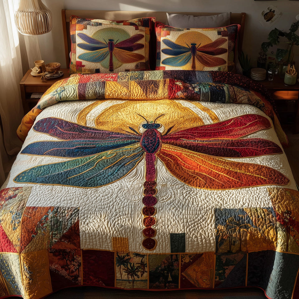 Sunshine Dragonfly Amber Patchwork quilted bedding set, quilt and two pillow shams on a made bed