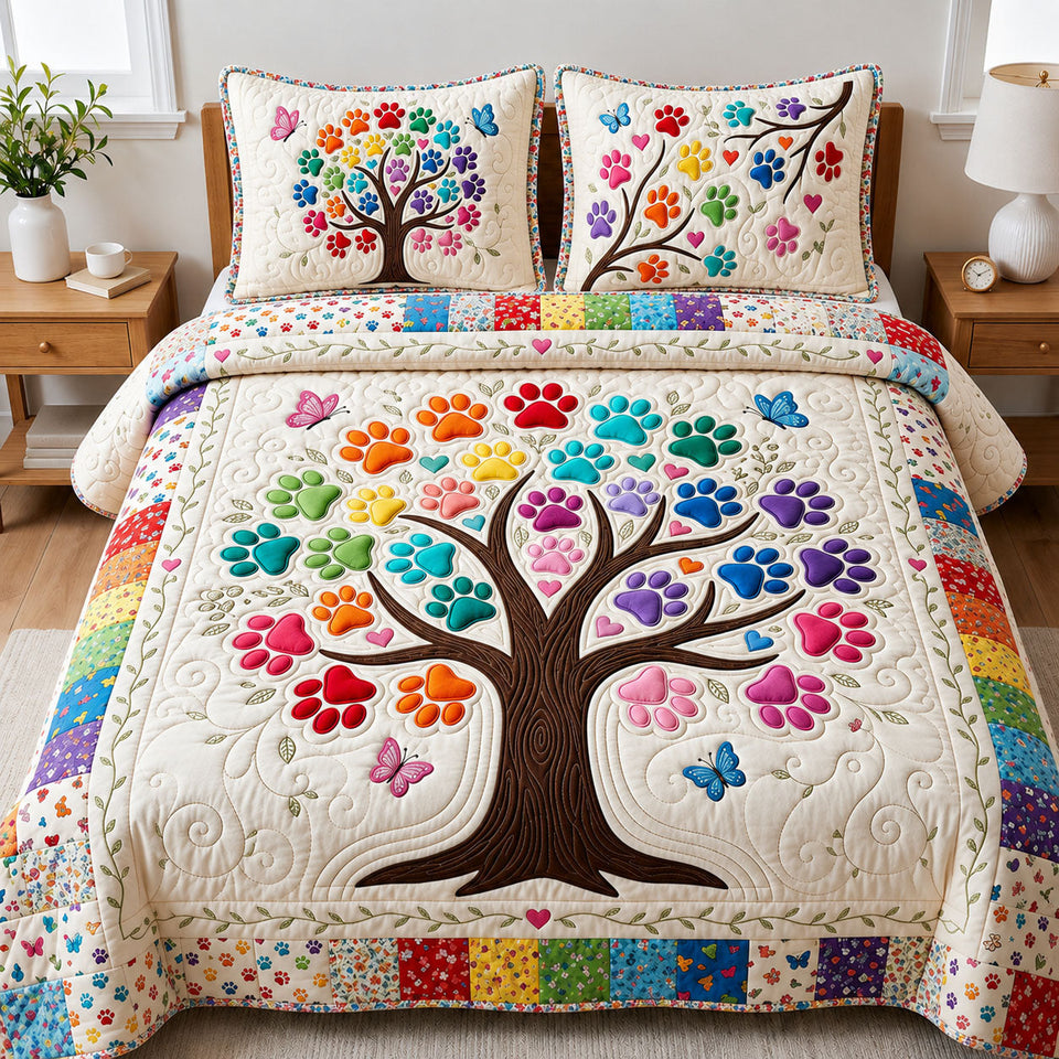 Tree of Paw quilted bedding set, quilt and two pillow shams on a made bed