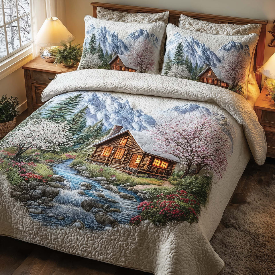 Woodland Haven Blossoms By The Cabin Stream quilted bedding set, quilt and two pillow shams on a made bed